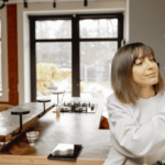 A person adjusts the temperature of their home with a modern thermostat.